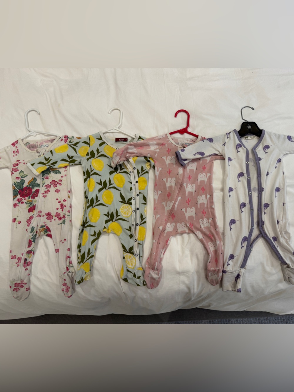 Four assorted sleeper onesies. Size 3 to 6 months.
